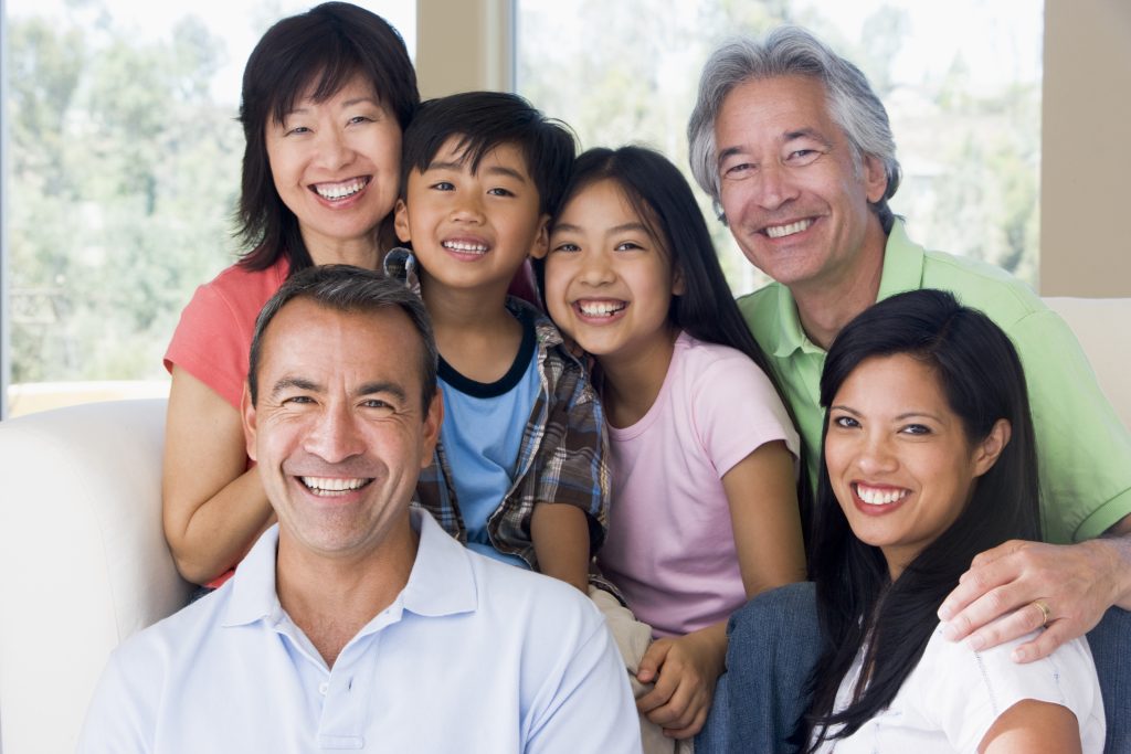 Extended family in living room smiling Extended family in living room smiling