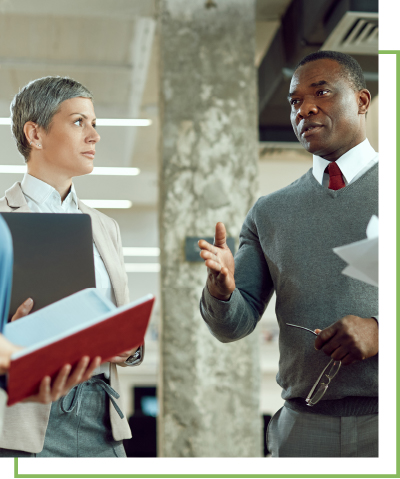 A man and a women have a discussion in a business setting.